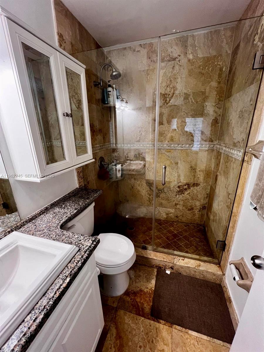 2551 West 64th Place Hialeah, FL 33016 - Photo 11 of 20 a bathroom with a granite countertop sink toilet and shower