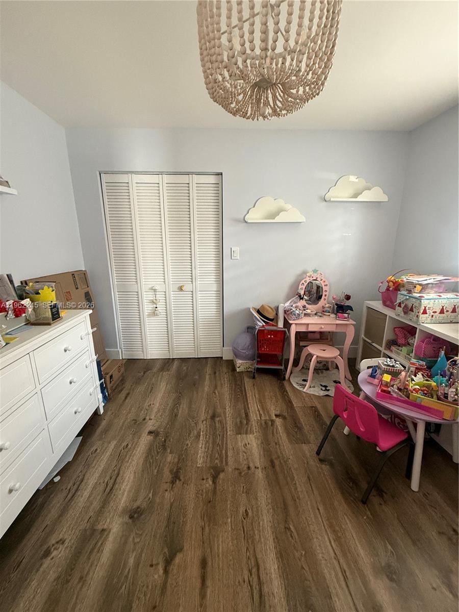2551 West 64th Place Hialeah, FL 33016 - Photo 13 of 20 a bedroom with furniture and a wooden floor