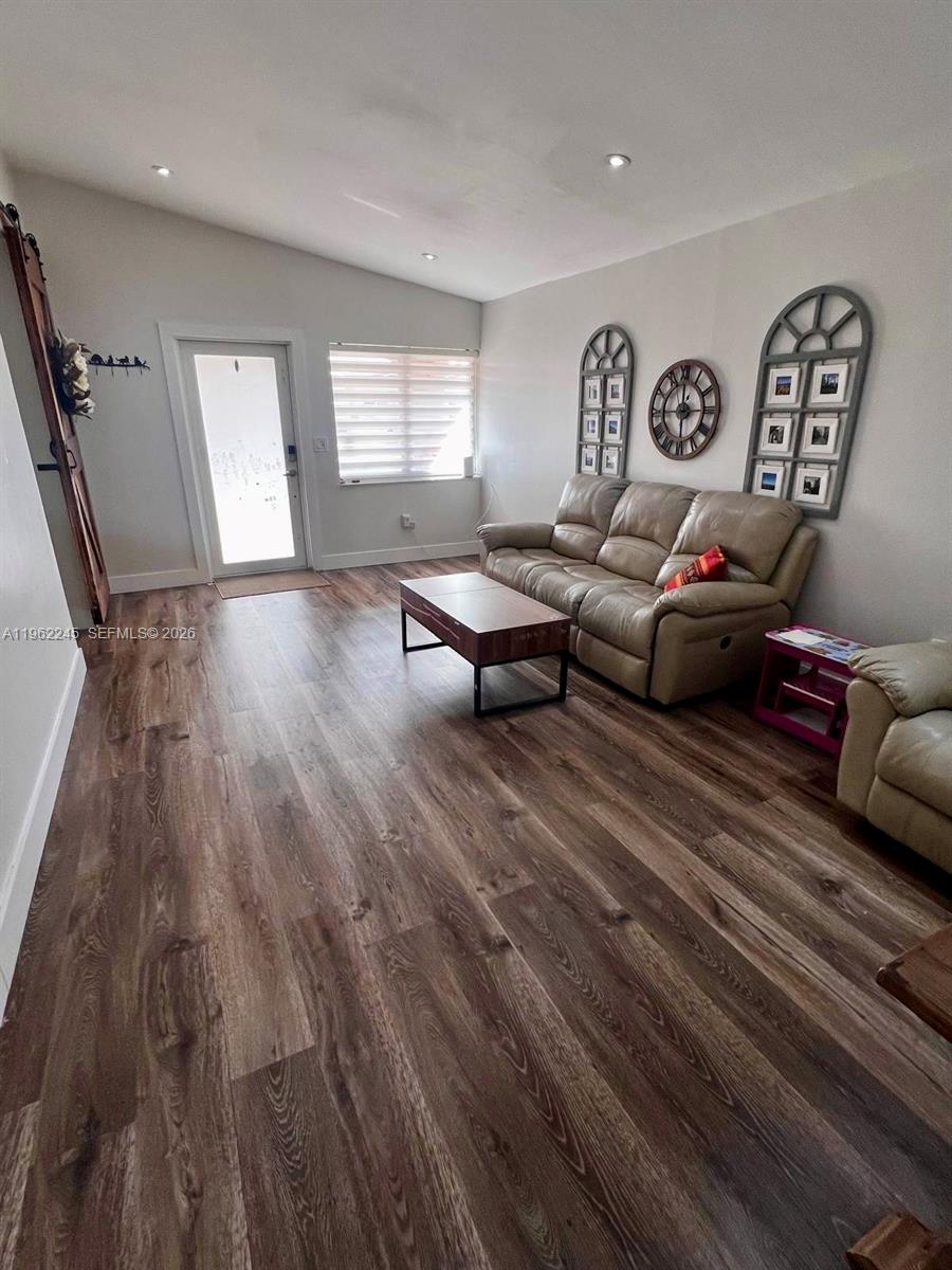 2551 West 64th Place Hialeah, FL 33016 - Photo 17 of 20 a living room with furniture and wooden floor