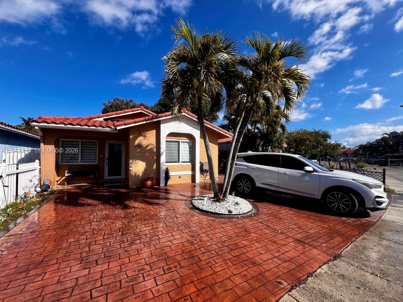 2551 West 64th Place Hialeah, FL 33016 - Photo 19 of 20 a view of a car parked in front of a house
