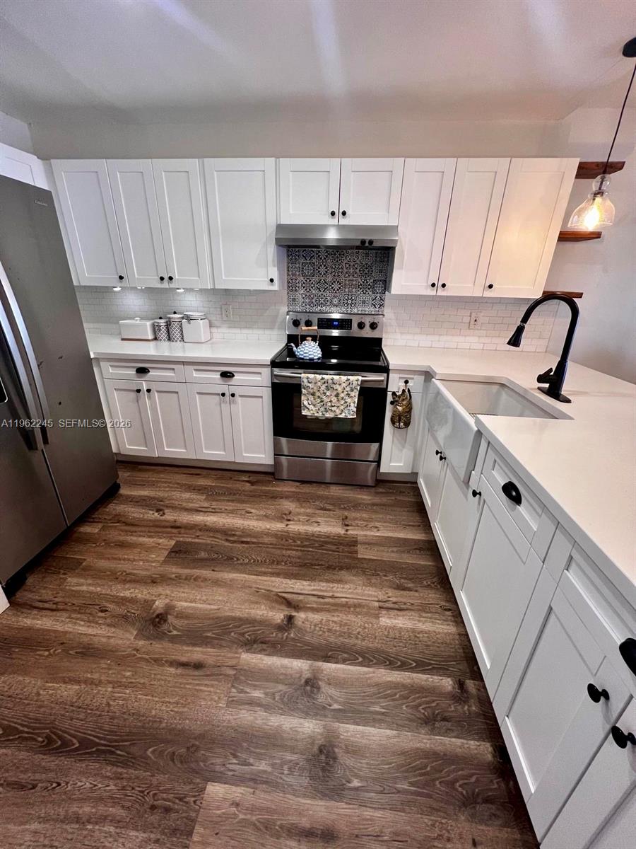 2551 West 64th Place Hialeah, FL 33016 - Photo 6 of 20 a kitchen with stainless steel appliances granite countertop a sink and a stove
