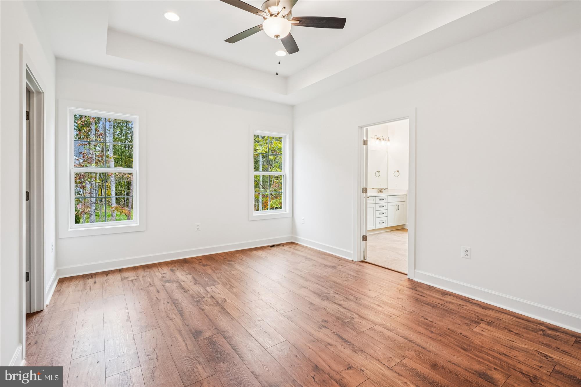 15017 Rillhurst Drive Culpeper, VA 22701 - Photo 17 of 34 an empty room with wooden floor chandelier fan and windows