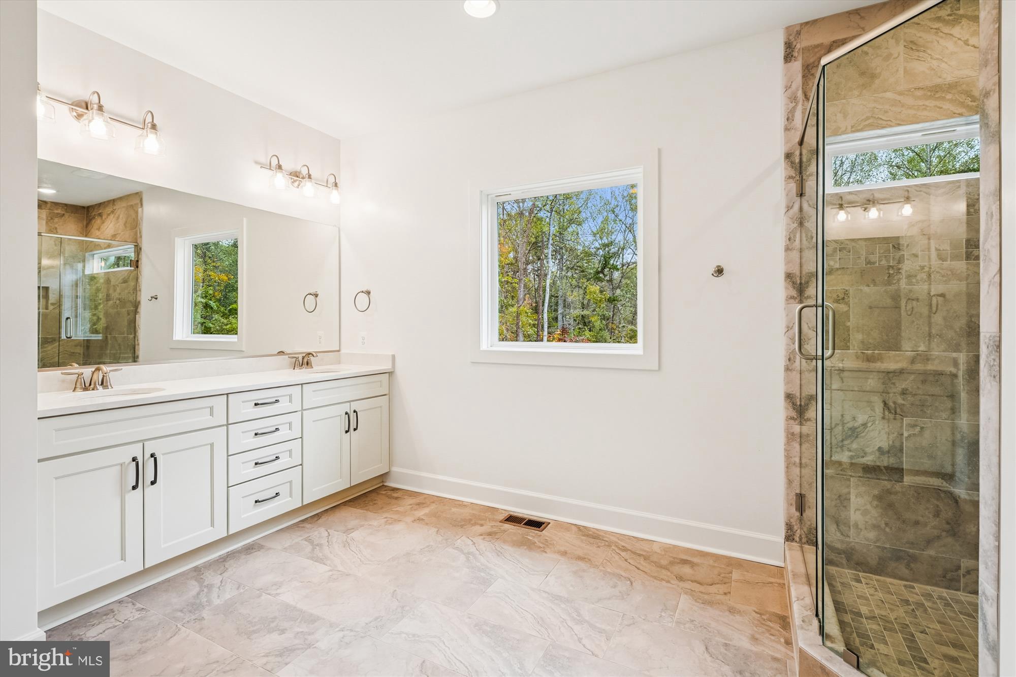 15017 Rillhurst Drive Culpeper, VA 22701 - Photo 20 of 34 a spacious bathroom with a shower sink and mirror