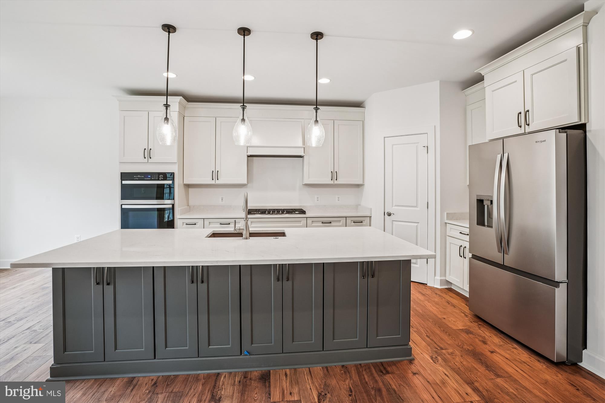 15017 Rillhurst Drive Culpeper, VA 22701 - Photo 4 of 34 a kitchen with kitchen island granite countertop a sink a center island stainless steel appliances and cabinets