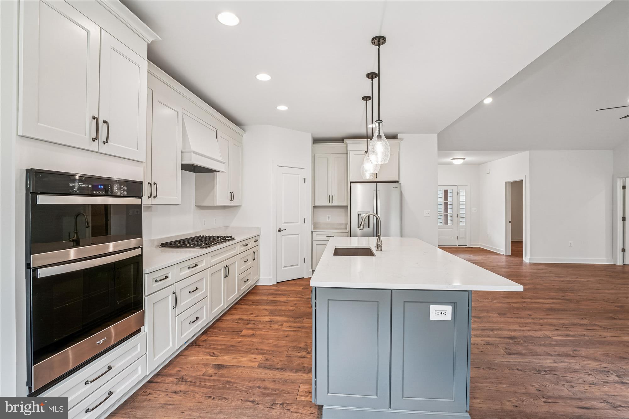 15017 Rillhurst Drive Culpeper, VA 22701 - Photo 5 of 34 a large kitchen with stainless steel appliances kitchen island granite countertop a stove a sink and a refrigerator