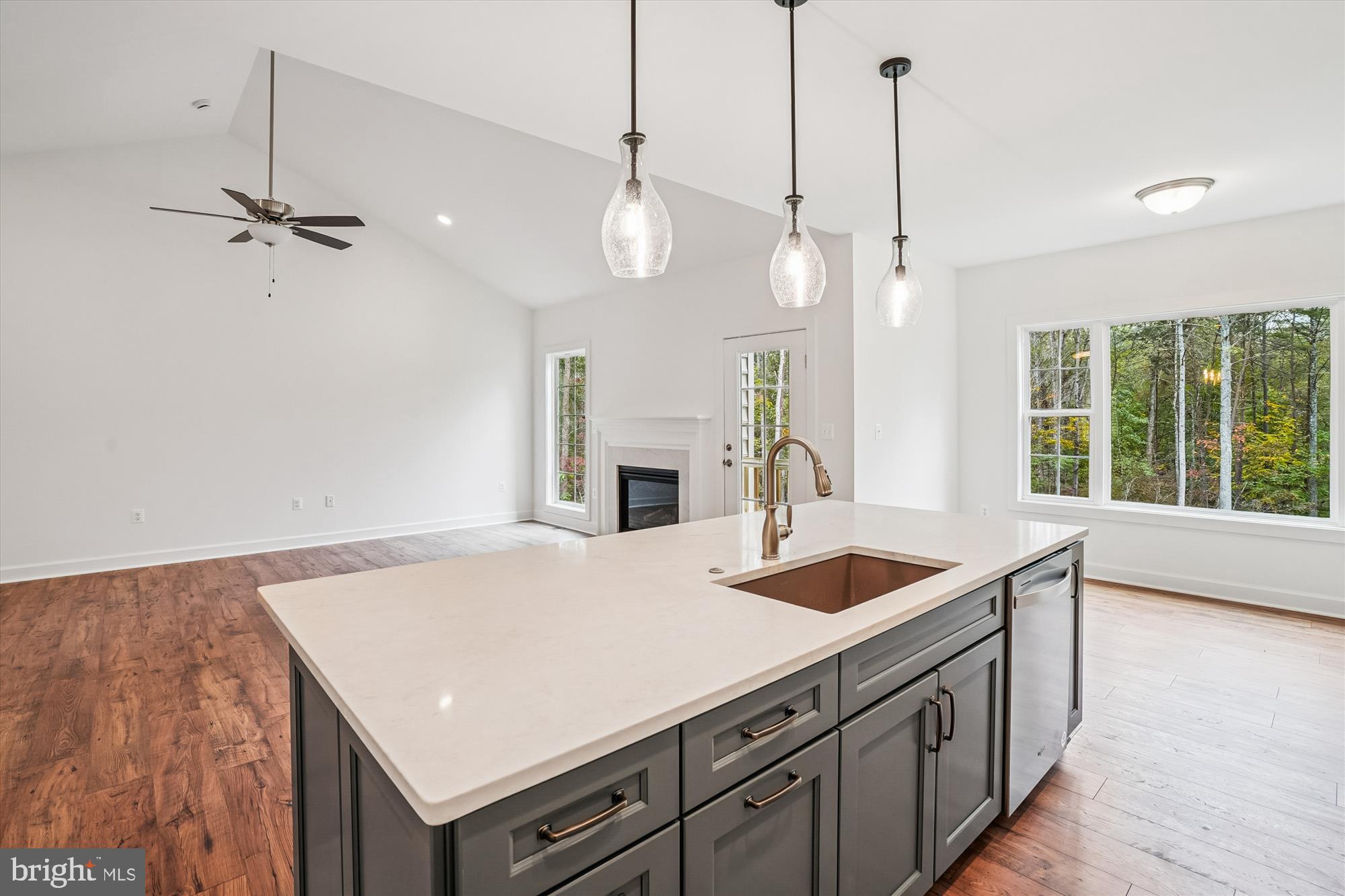 15017 Rillhurst Drive Culpeper, VA 22701 - Photo 6 of 34 a kitchen with a sink a center island a stove and a wooden floor