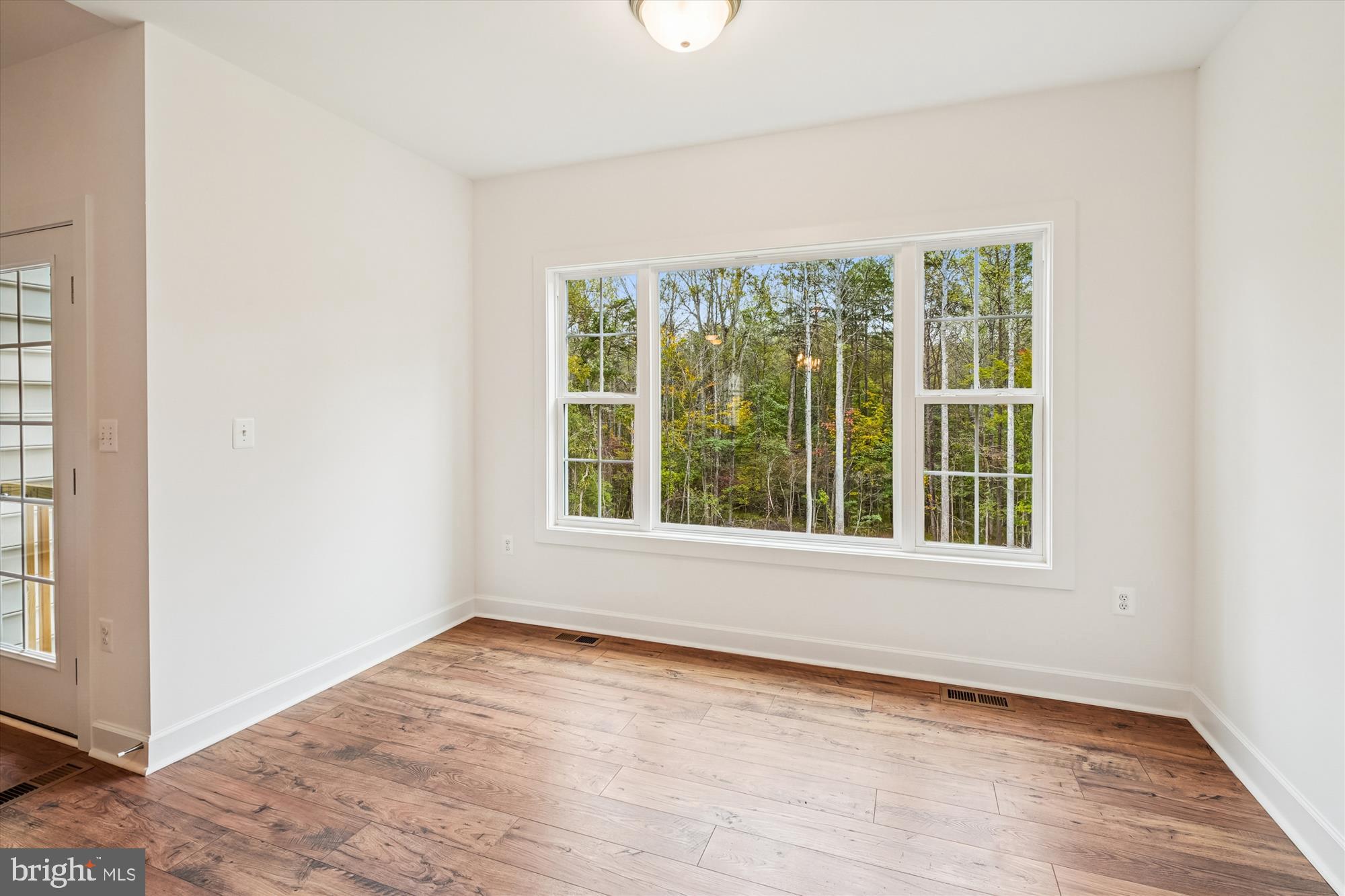 15017 Rillhurst Drive Culpeper, VA 22701 - Photo 7 of 34 an empty room with wooden floor and windows