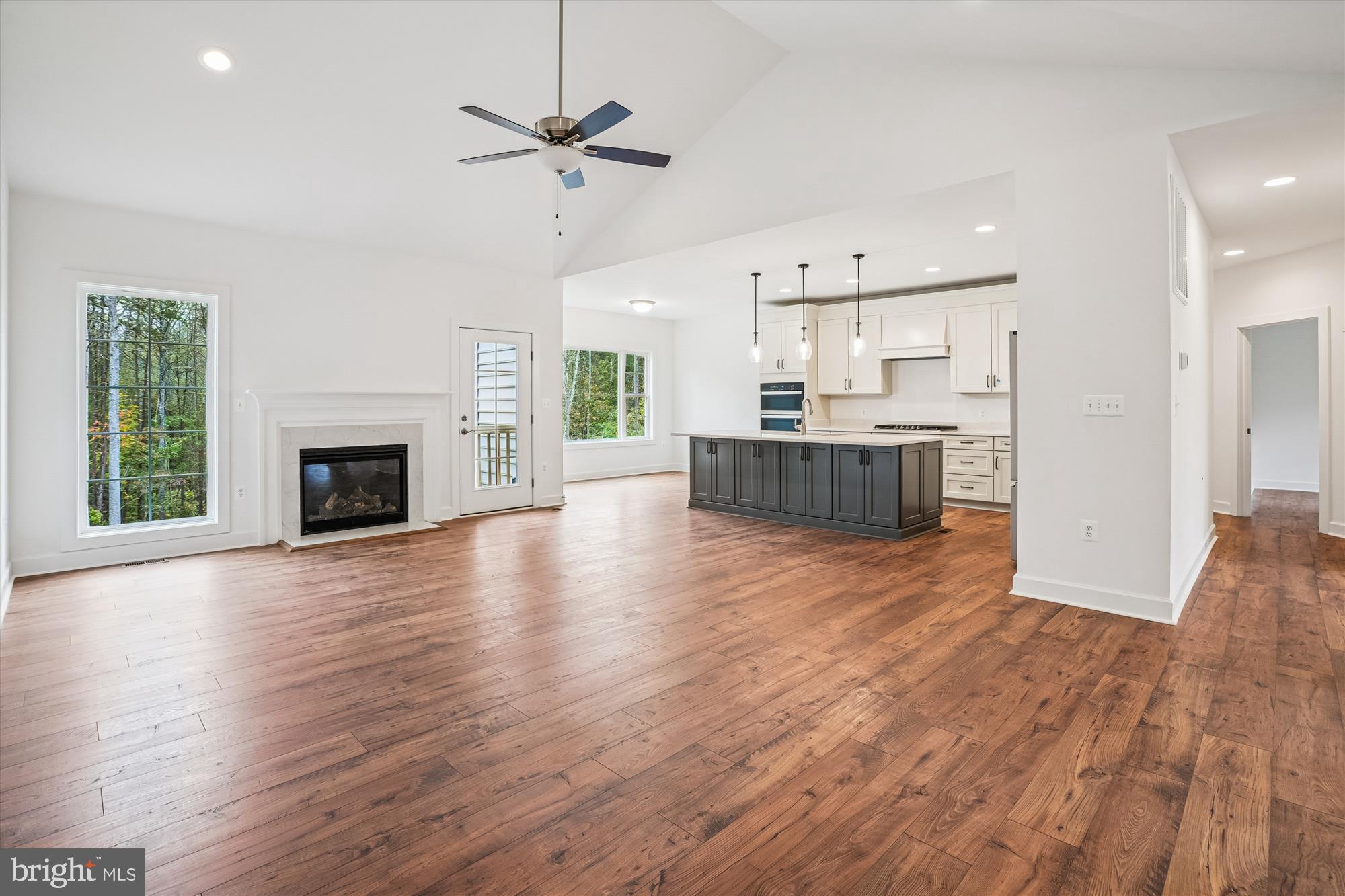 15017 Rillhurst Drive Culpeper, VA 22701 - Photo 8 of 34 a view of a kitchen with furniture a ceiling fan and wooden floor
