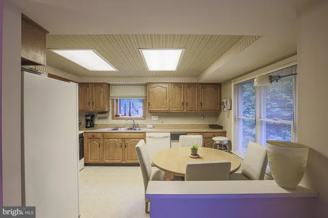 a kitchen with a sink cabinets and window