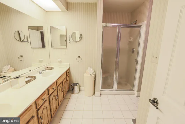 a spacious bathroom with a shower sink and mirror