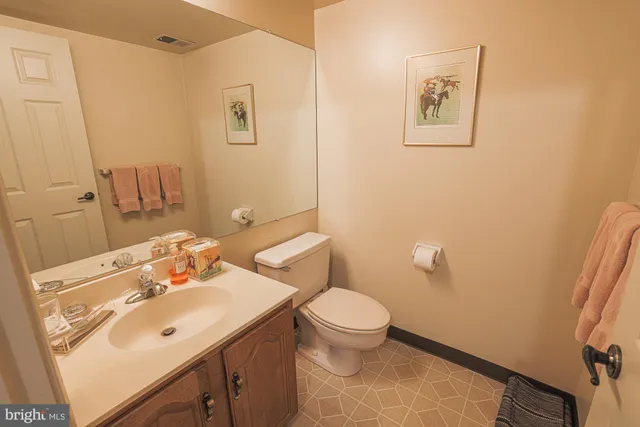 a bathroom with a sink mirror and toilet