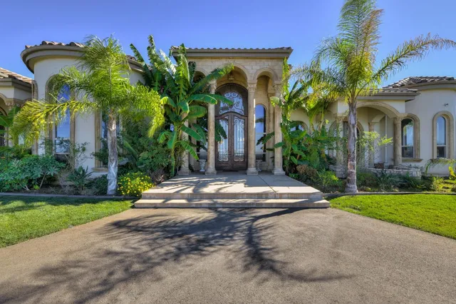 a front view of a house with garden