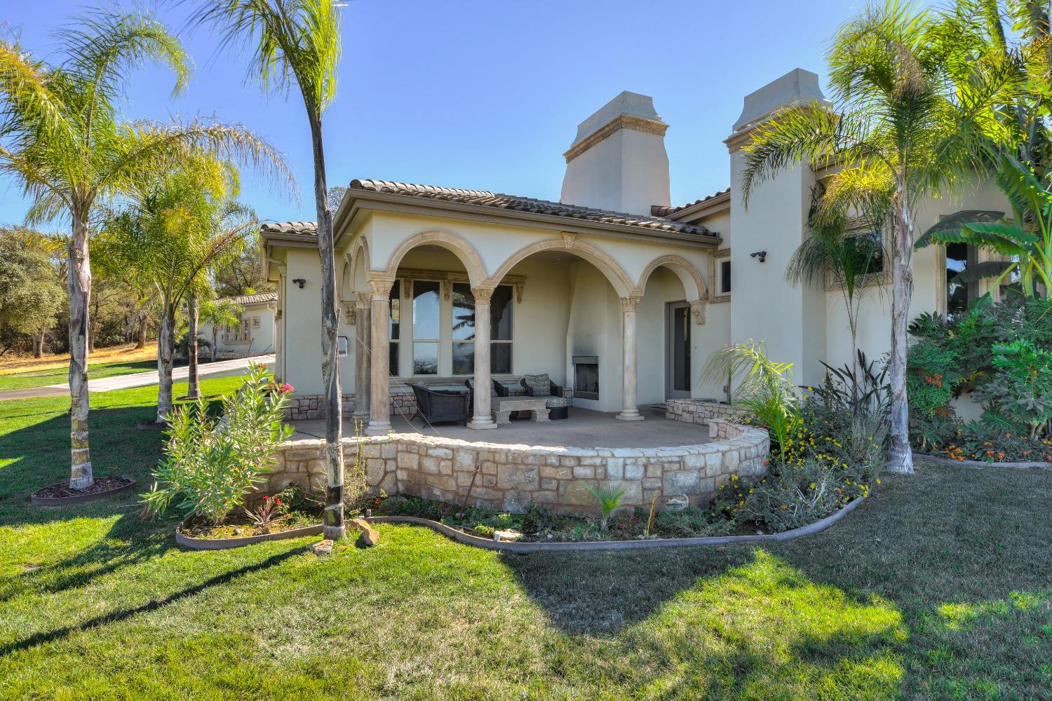 2070 West Green Springs Road El Dorado Hills, CA 95762 - Photo 17 of 75 a view of a house with a small yard plants and palm trees