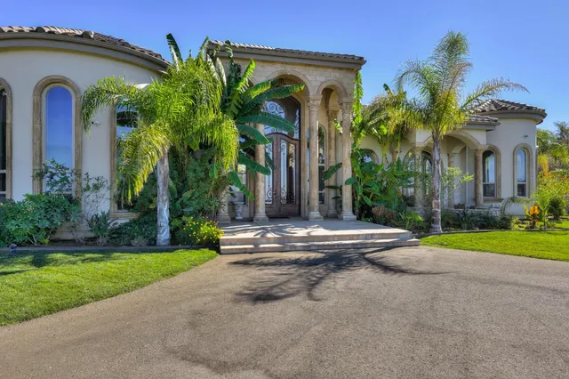a view of a house with swimming pool and sitting area