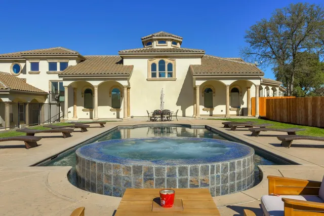 a view of a dining room with furniture and chandelier
