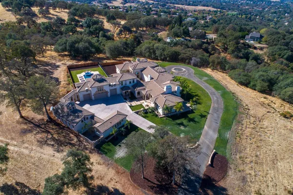 a view of a house with a swimming pool and a yard