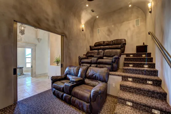 a living room with furniture a rug and white walls