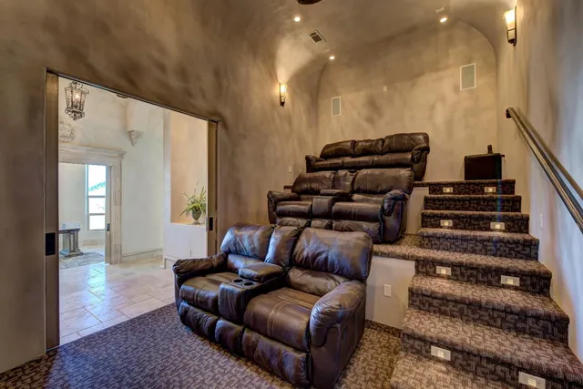 a living room with furniture a rug and white walls