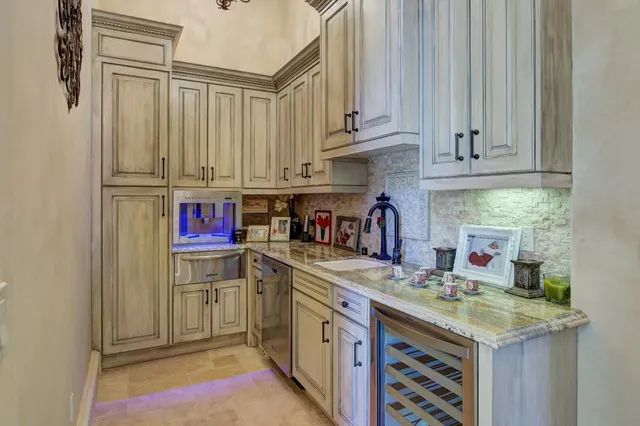 a living room with furniture a fireplace and a chandelier
