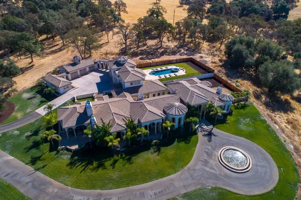 an aerial view of a house with balcony and garden