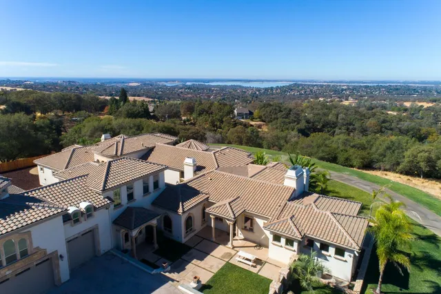 an aerial view of a house with a yard