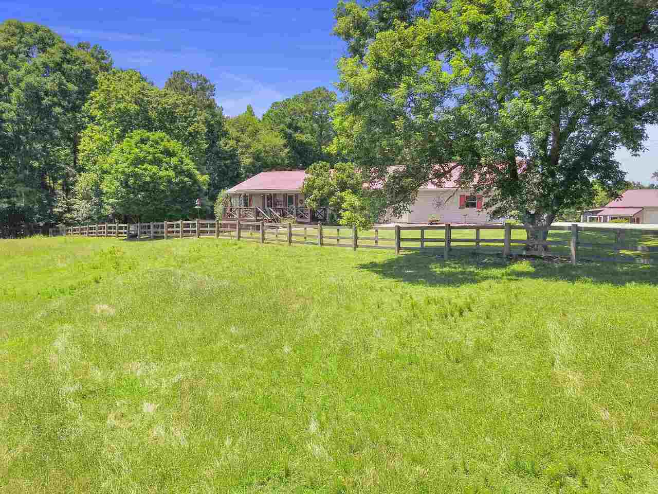 227 Lincoln Road Tyrone, GA 30290 - Photo 1 of 1 a backyard of a house with table and chairs