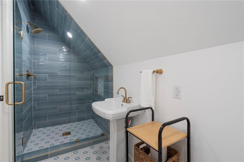 403 Rockbridge Road Southwest Lilburn, GA 30047 - Photo 49 of 77 a bathroom with a sink mirror toilet and shower