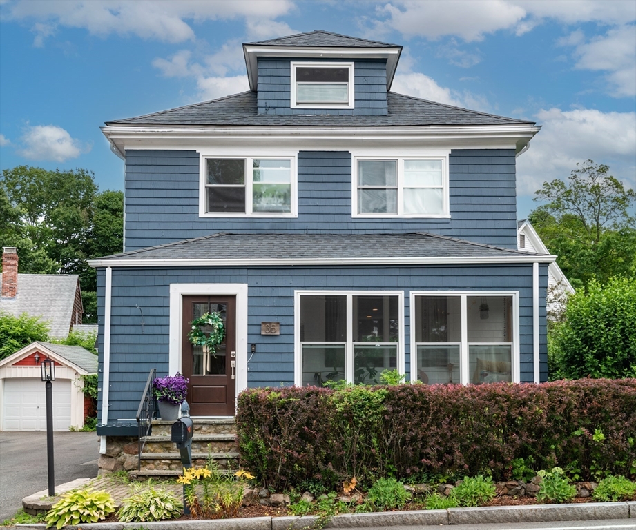 a front view of a house with garden and porch