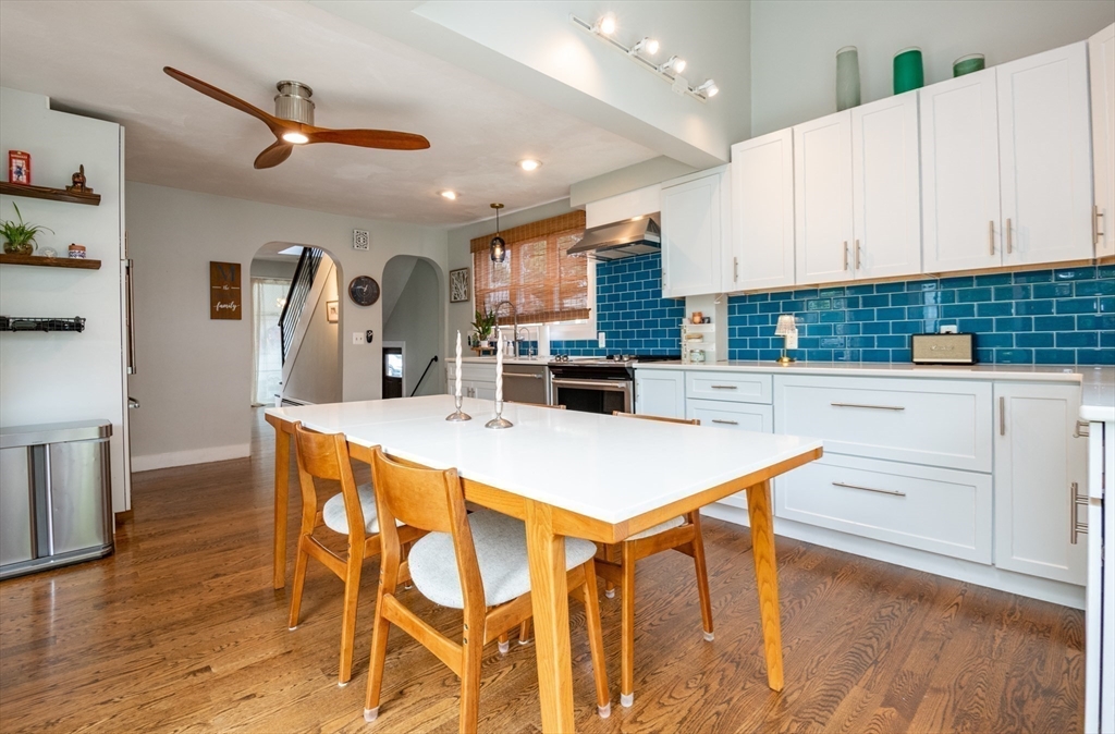 35 Central Street Middleton, MA 01949 - Photo 15 of 42 a kitchen with stainless steel appliances kitchen island granite countertop a table chairs sink and cabinets
