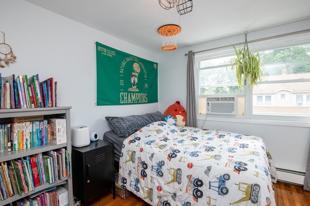 35 Central Street Middleton, MA 01949 - Photo 27 of 42 a bedroom with a bed and a book shelf