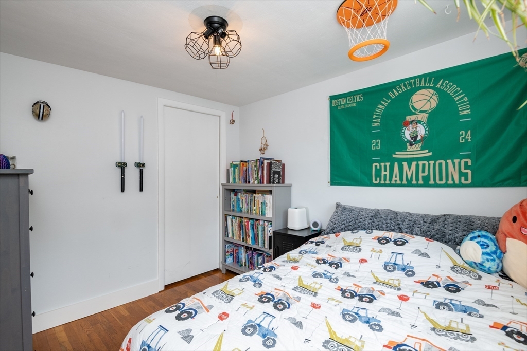 35 Central Street Middleton, MA 01949 - Photo 28 of 42 a bedroom with a bed and a book shelf
