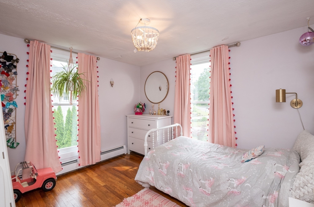 35 Central Street Middleton, MA 01949 - Photo 29 of 42 a bed room with a bed mirror and a window