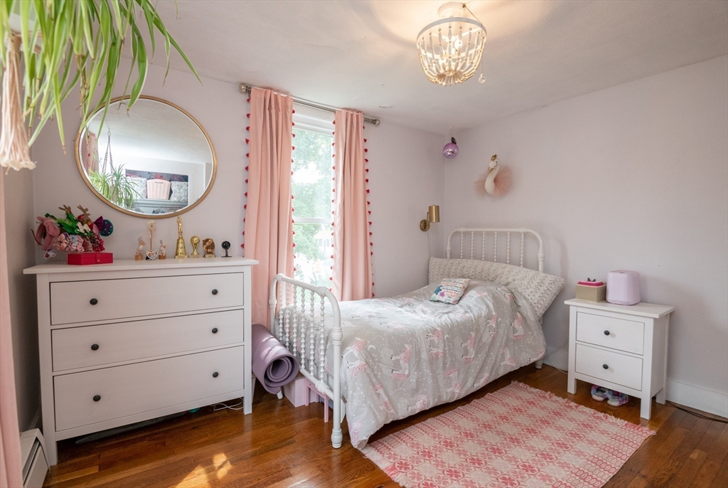 35 Central Street Middleton, MA 01949 - Photo 30 of 42 a bedroom with a bed and a mirror