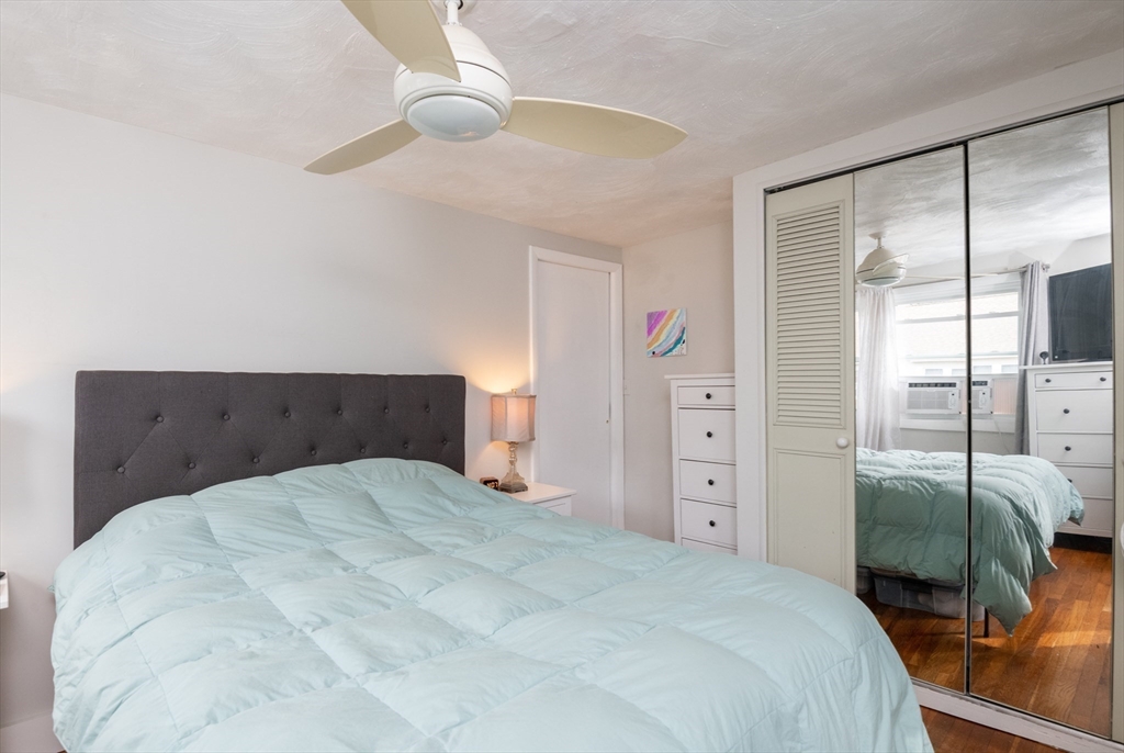 35 Central Street Middleton, MA 01949 - Photo 32 of 42 a bedroom with a large bed and a chandelier