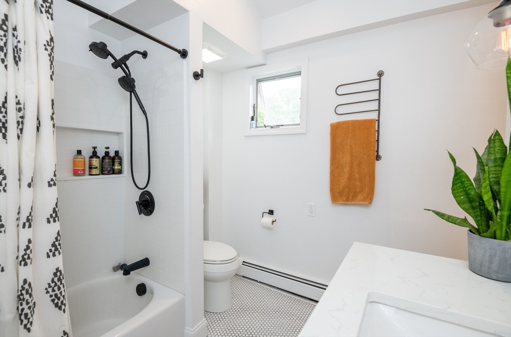 35 Central Street Middleton, MA 01949 - Photo 33 of 42 a bath room with a toilet and a bath tub