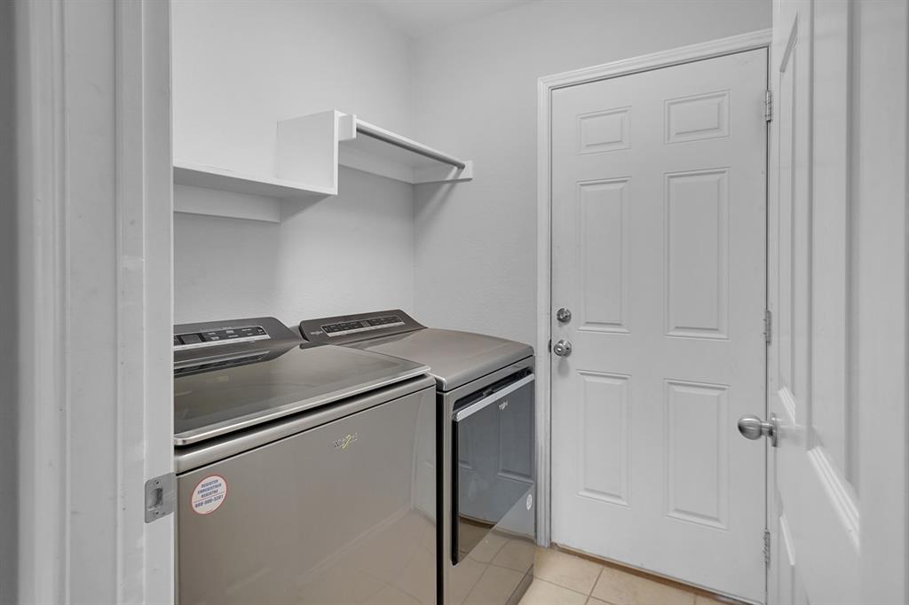 2609 Cowboy Trail Little Elm, TX 75068 - Photo 19 of 34 Washroom featuring light tile patterned flooring and washing machine and clothes dryer