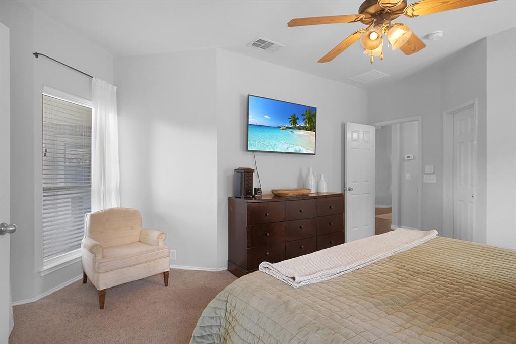 2609 Cowboy Trail Little Elm, TX 75068 - Photo 22 of 34 Carpeted bedroom featuring a ceiling fan and multiple windows