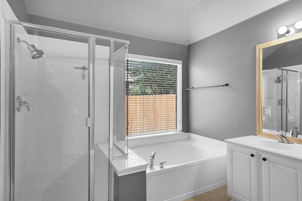 2609 Cowboy Trail Little Elm, TX 75068 - Photo 25 of 34 Bathroom with vanity, a stall shower, a bath, a textured wall, and light tile patterned floors