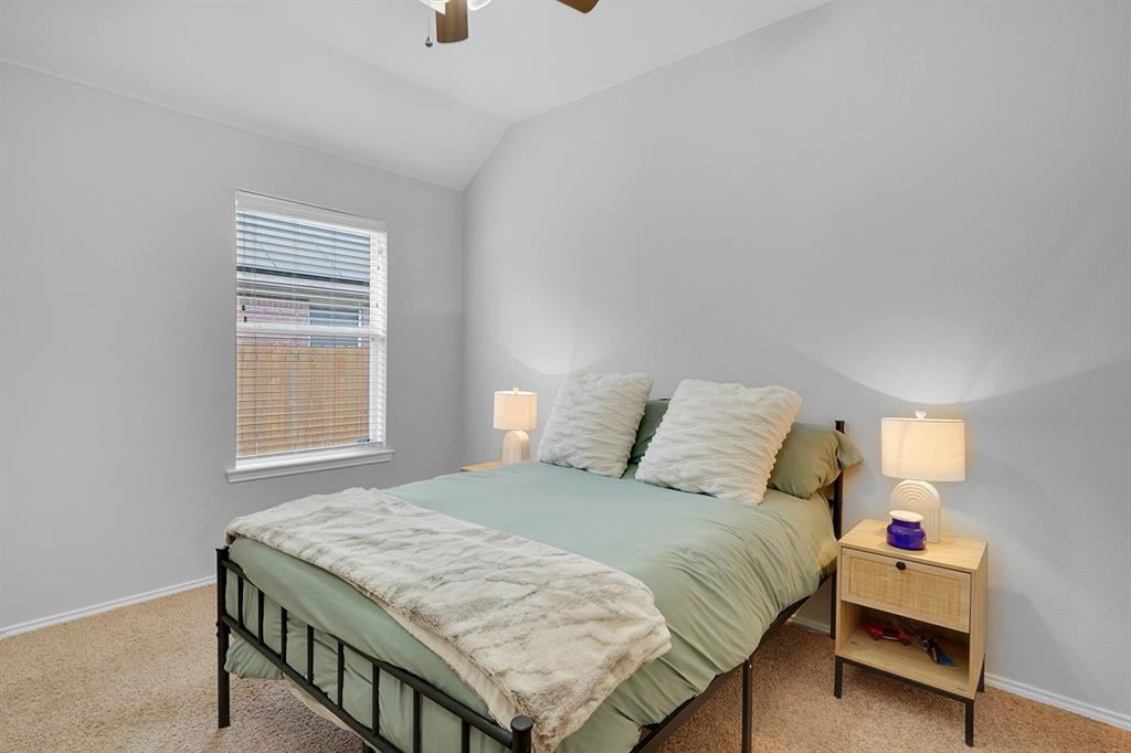 2609 Cowboy Trail Little Elm, TX 75068 - Photo 26 of 34 Bedroom with light carpet, vaulted ceiling, and ceiling fan