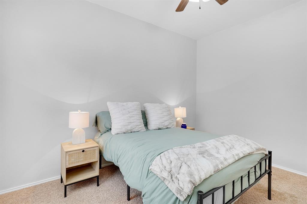 2609 Cowboy Trail Little Elm, TX 75068 - Photo 27 of 34 Carpeted bedroom with baseboards and ceiling fan