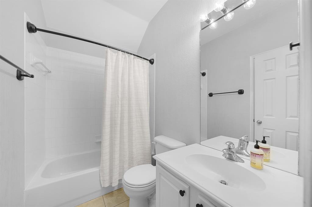 2609 Cowboy Trail Little Elm, TX 75068 - Photo 30 of 34 Bathroom featuring vanity, light tile patterned floors, and shower / tub combo