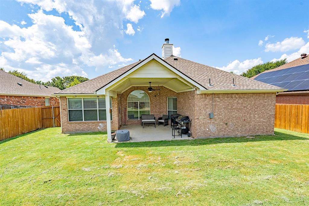 2609 Cowboy Trail Little Elm, TX 75068 - Photo 33 of 34 Back of house with a ceiling fan, a fenced backyard, a patio, and roof with shingles