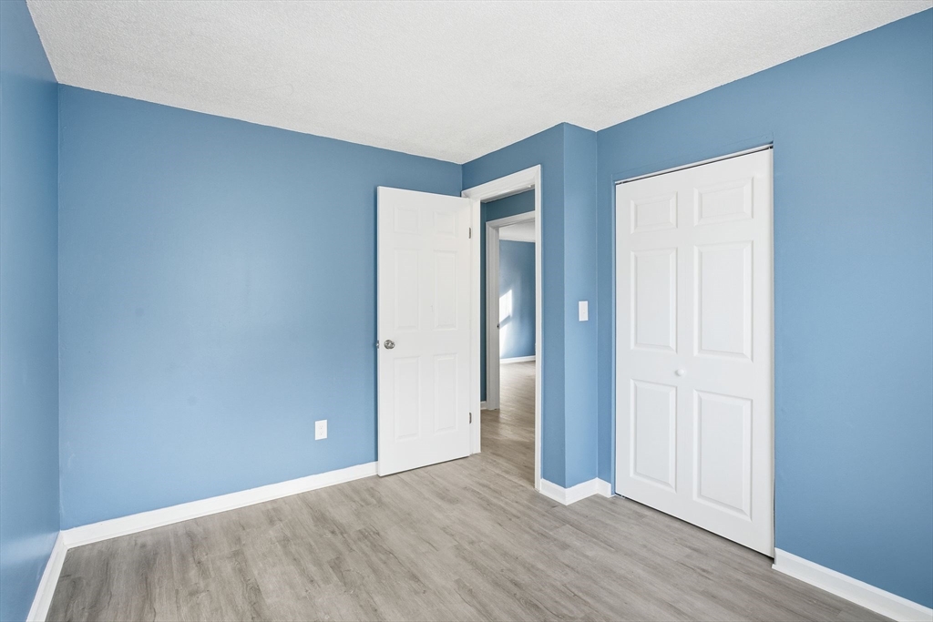 19 Emily Street Springfield, MA 01109 - Photo 16 of 41 an empty room with wooden floor and closet
