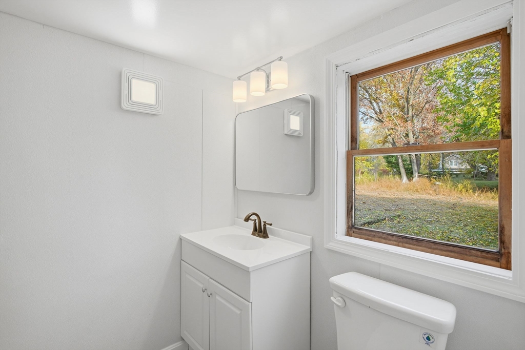 19 Emily Street Springfield, MA 01109 - Photo 25 of 41 a bathroom with a sink a toilet and a window