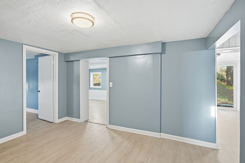 19 Emily Street Springfield, MA 01109 - Photo 31 of 41 an empty room with wooden floor and windows