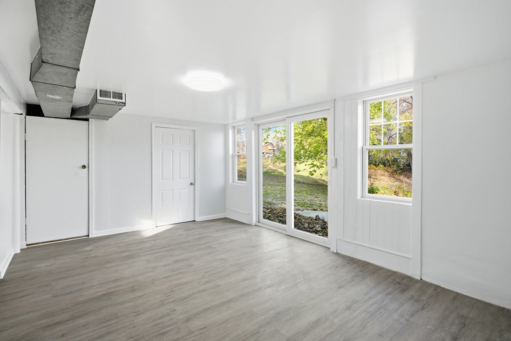 19 Emily Street Springfield, MA 01109 - Photo 35 of 41 a view of an empty room with wooden floor and a window