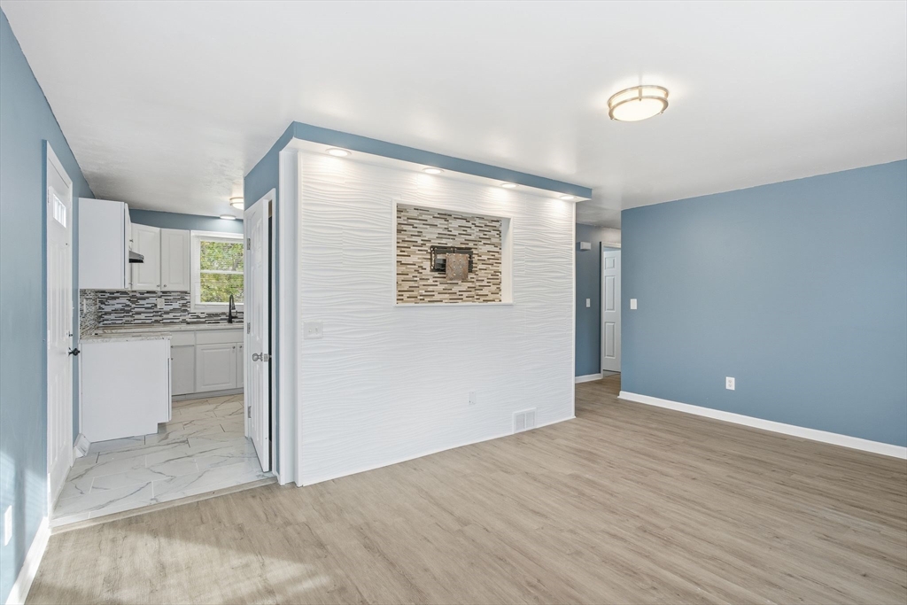 19 Emily Street Springfield, MA 01109 - Photo 8 of 41 a view of an empty room with kitchen and a window