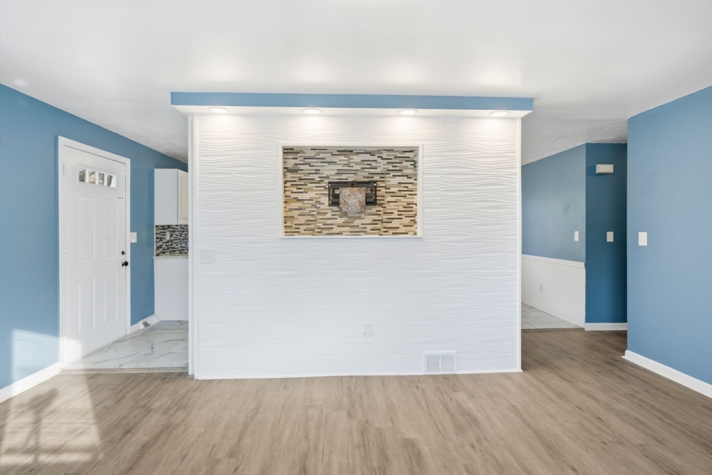 19 Emily Street Springfield, MA 01109 - Photo 9 of 41 a view of an empty room with wooden floor and a window