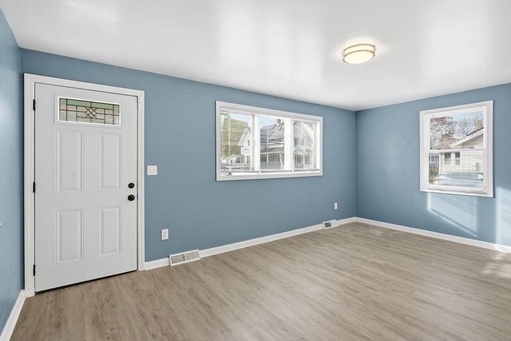 19 Emily Street Springfield, MA 01109 - Photo 10 of 41 a view of an empty room with wooden floor and a window