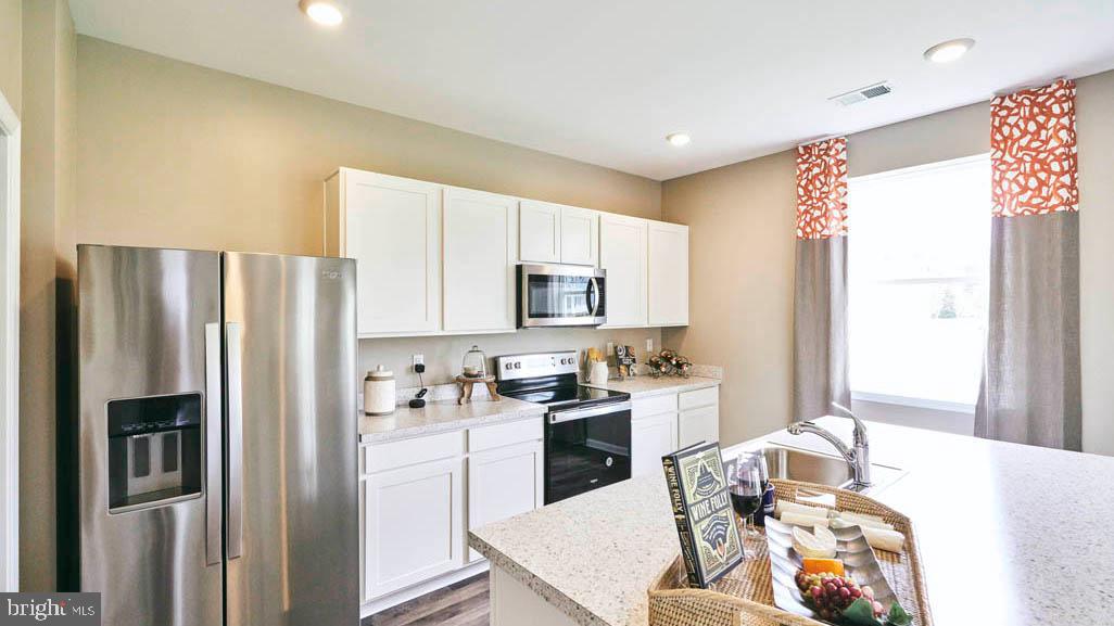 55 Buttercup Circle Elkton, MD 21921 - Photo 7 of 36 a kitchen with stainless steel appliances granite countertop a refrigerator sink and stove